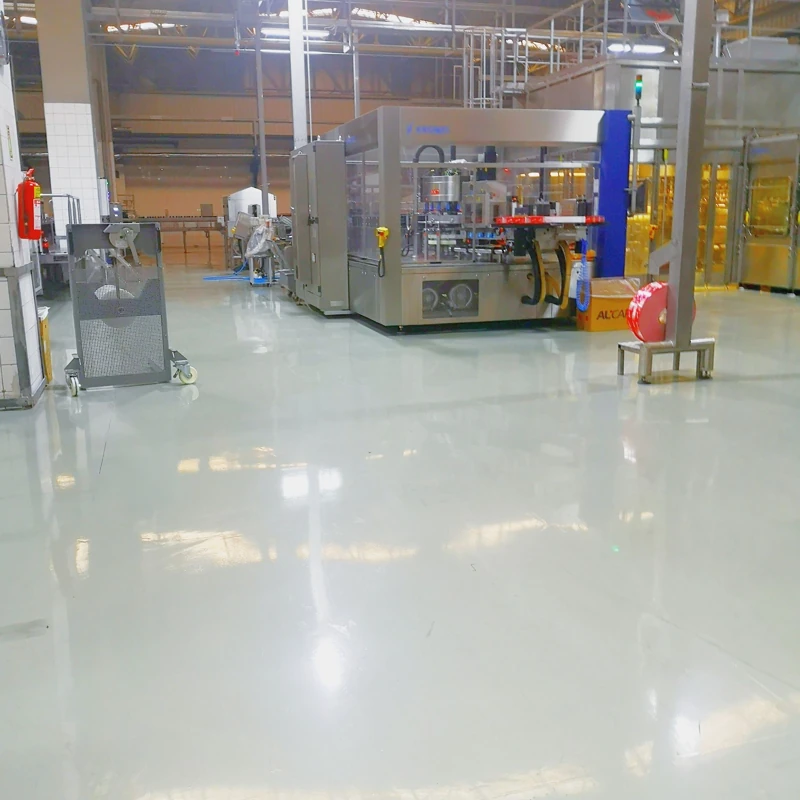 High-gloss self-leveling epoxy flooring in an industrial manufacturing facility.