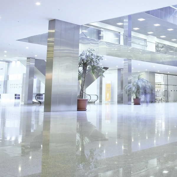 Modern office lobby with highly reflective epoxy flooring and metallic pillars.
