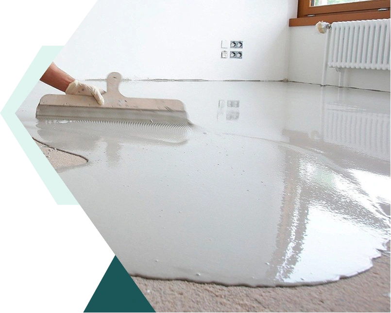 Spreading light grey self-leveling epoxy with a notched squeegee.